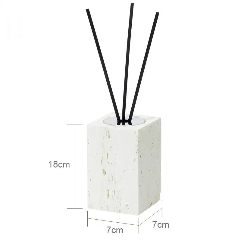 Beige travertine marble reed diffuser with white textured stone base and four black reeds from decorbites bathroom set