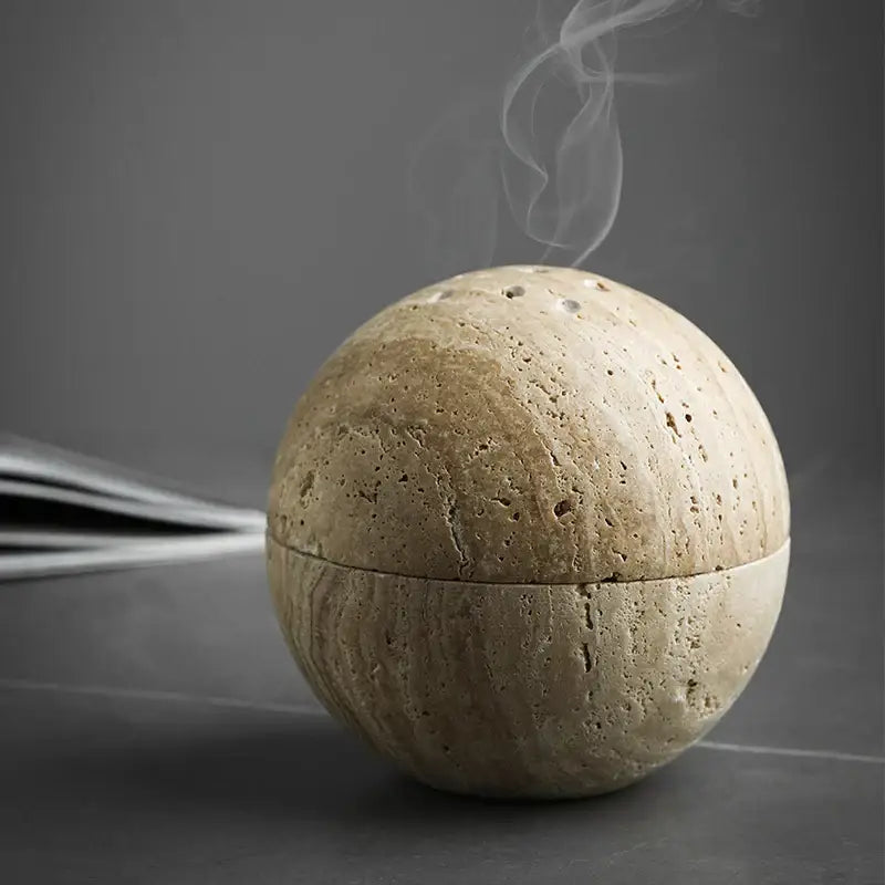 Beige travertine marble sphere incense burner with textured porous surface and subtle seam for living room decorbites decor