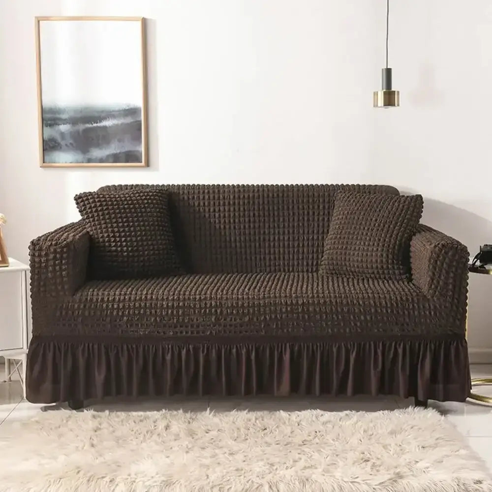 Brown textured solid color cozy sofa cover with ruffled hem and matching pillow covers for living room use
