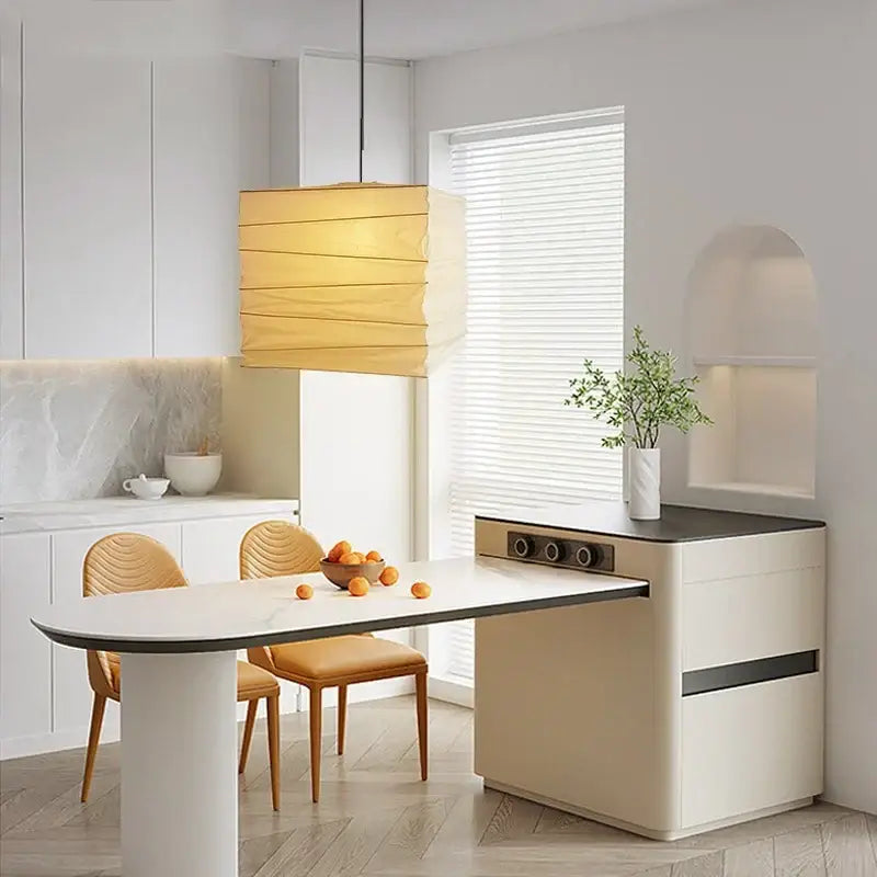 Modern beige kitchen island with sleek black countertop and decorbites cube rice paper pendant lamp for living room decor