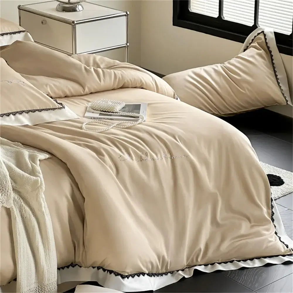 Beige and white hot diamond lace bedding set featuring cream satin duvet cover with black lace trim and embroidered script