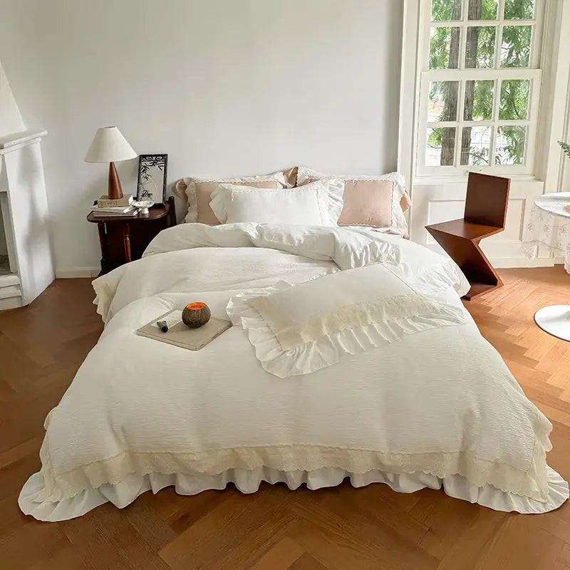 Beige and white textured cotton bedding set with lace ruffles and matching duvet cover and pillowcases