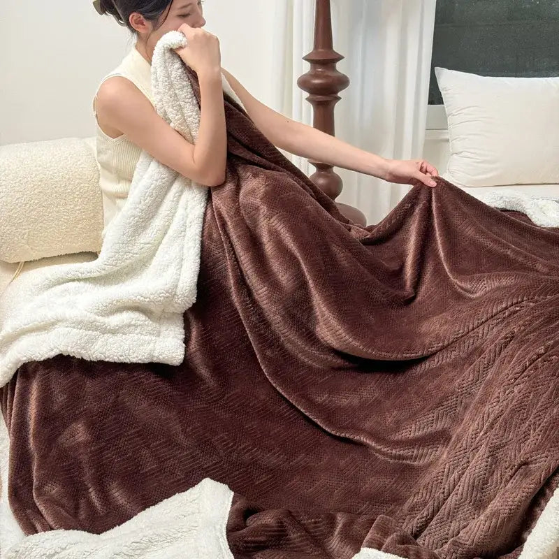 Brown plush fleece jacquard blanket with textured herringbone pattern and white sherpa lining for bedroom use