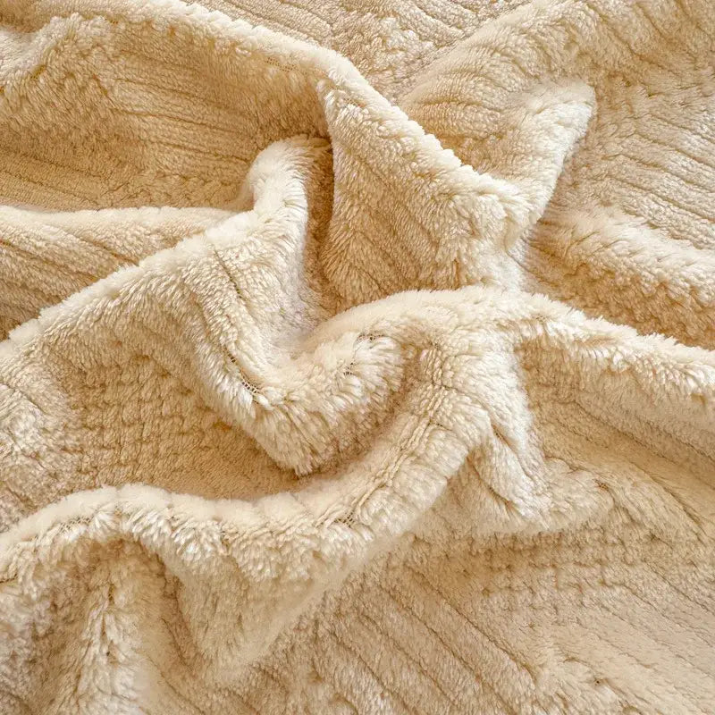 Beige and white ribbed coral fleece jacquard blanket with a cream-colored plush textured surface for bedroom use