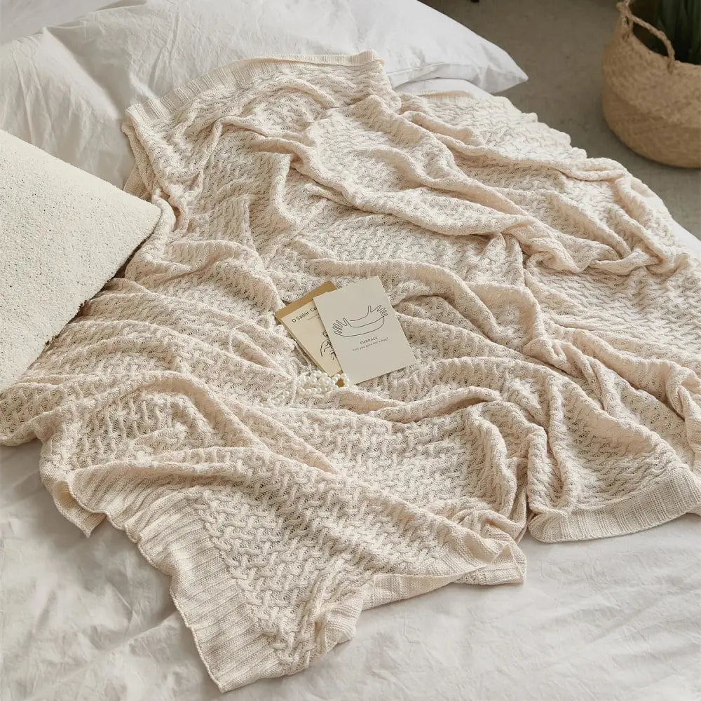 Cream-colored knitted bamboo throw blanket with textured cable knit pattern for decorbites cool summer air conditioning use