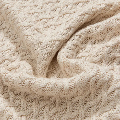 Cream-colored cable-knit bamboo sweater with textured pattern ideal for decorbites cool summer air conditioning use