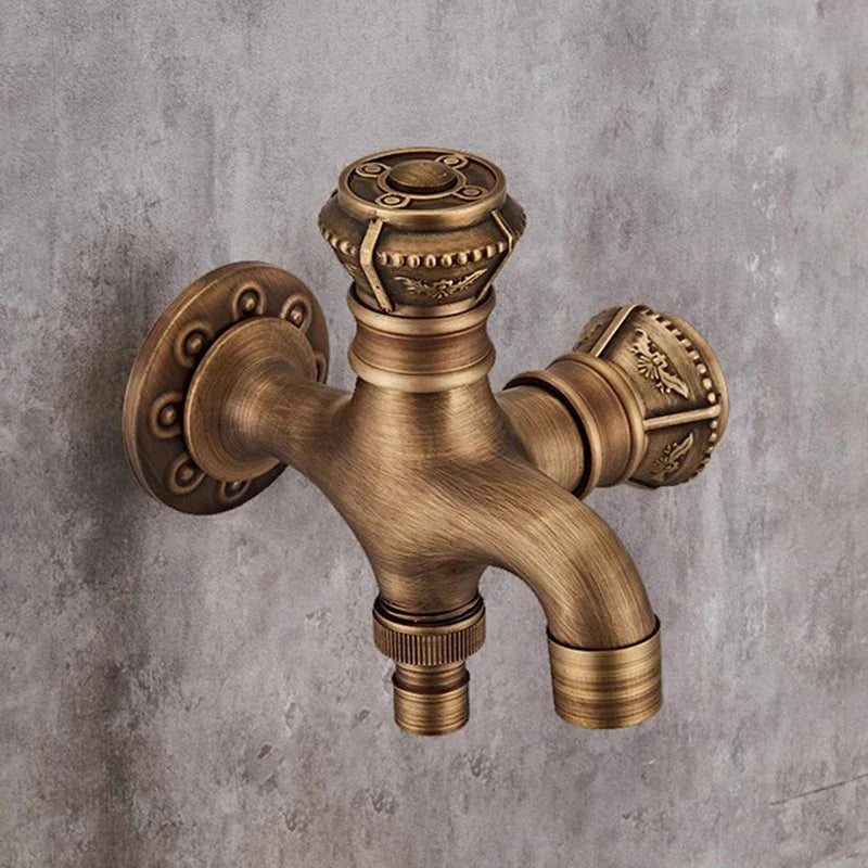 Antique bronze wall mounted bibcock with double handles and ornate floral detailing for garden and outdoor use