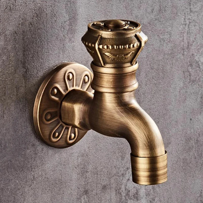 Antique brass-finished wall mounted bibcock tap with ornate vintage detailing and decorative knob for garden and kitchen use