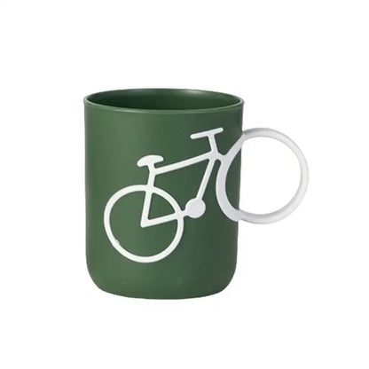 Dark green ceramic toothbrush holder cup with white bicycle silhouette design and integrated circular handle for bathroom use