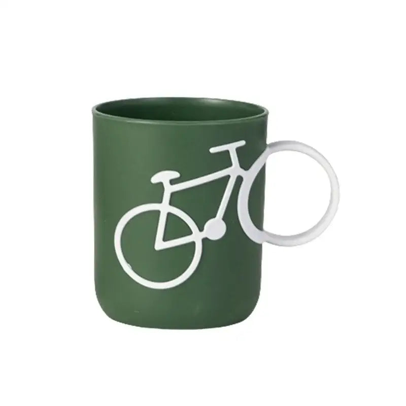 Dark green ceramic toothbrush holder cup with white bicycle silhouette design and integrated circular handle for bathroom use