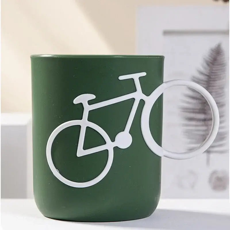 Dark green ceramic toothbrush holder cup with white bicycle silhouette design for bathroom use