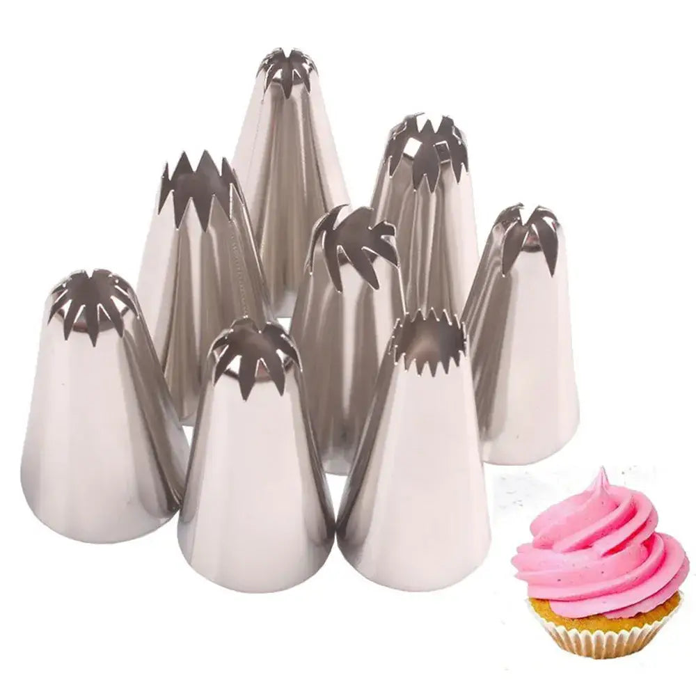 Set of stainless steel decorbites big size russian pastry nozzles with star-shaped tips next to a pink cupcake