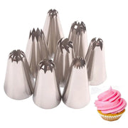 Set of stainless steel decorbites big size russian pastry nozzles with star-shaped tips next to a pink cupcake