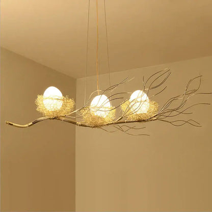 Golden branch-style nest led pendant light with three white spherical bulbs for dining room and cafe decor