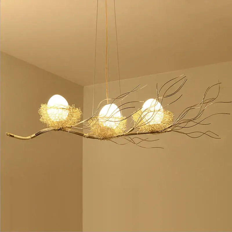 Golden branch-style nest led pendant light with three white spherical bulbs for dining room and cafe decor