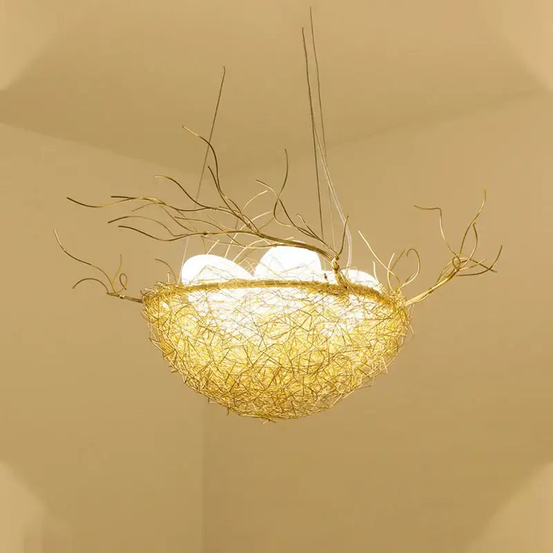 Golden wire nest led pendant light with delicate branch extensions and glowing white bulbs for dining room decor