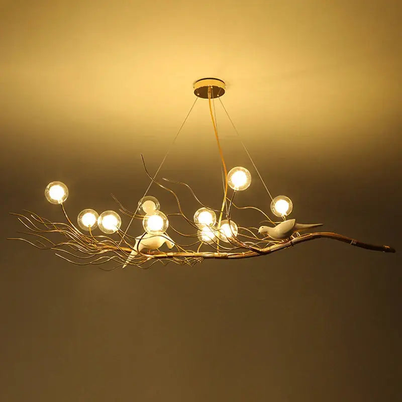Warm-toned metal bird nest led pendant light resembling a branch with birds featuring spherical bulbs for dining room decor