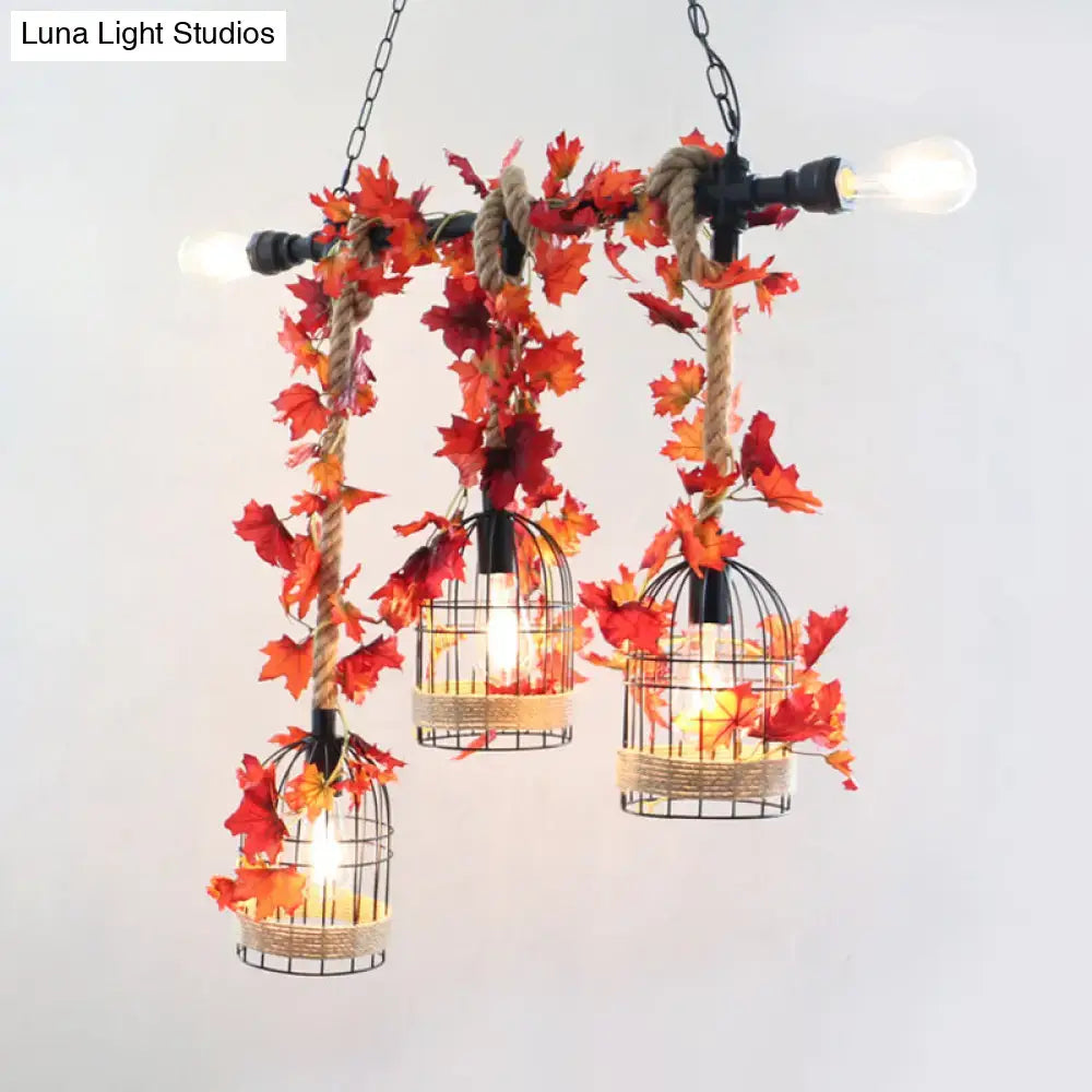 Rustic black wire birdcage chandelier with rose red metal pendant and artificial orange red maple leaf accents