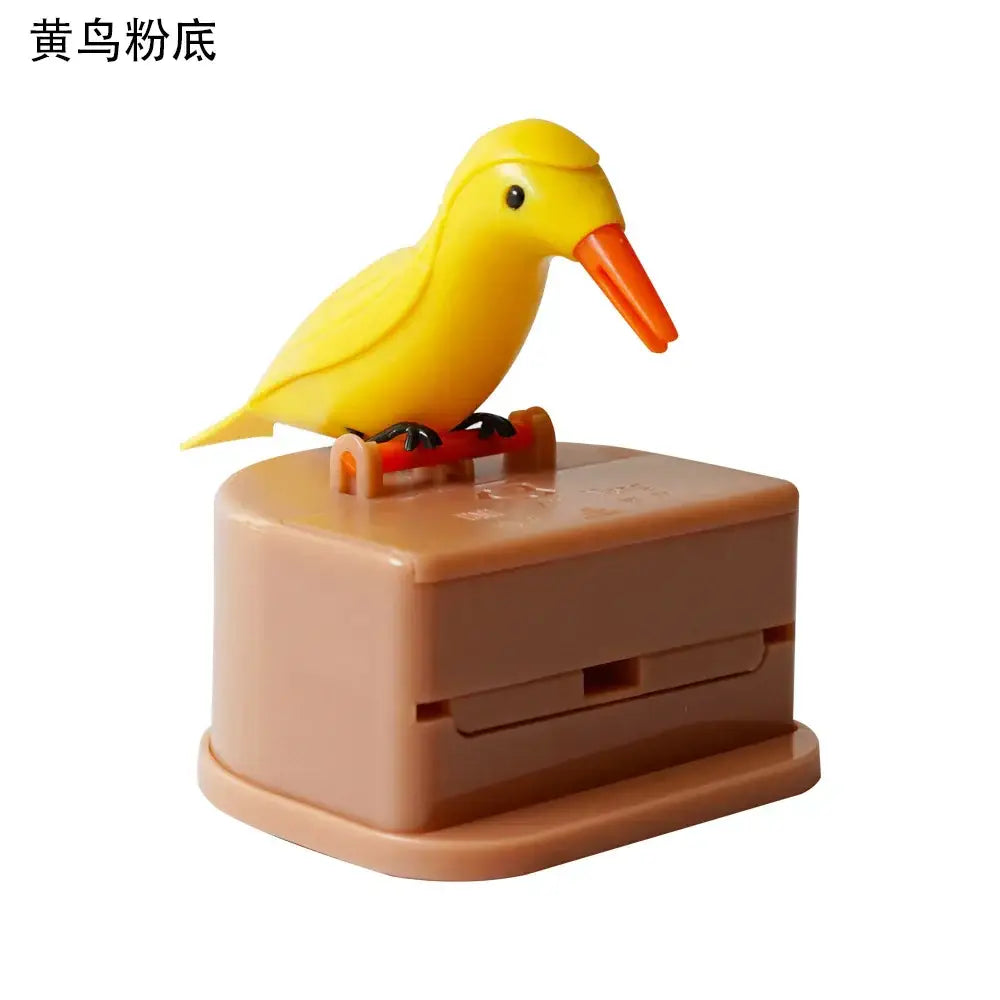 A cheerful yellow plastic decorbites birdie toothpick holder with an orange beak on a tan mechanical base