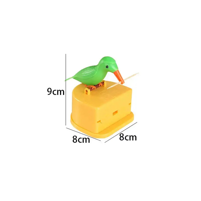 Green plastic bird with orange beak perched on yellow base decorbites birdie toothpick holder for kitchen storage