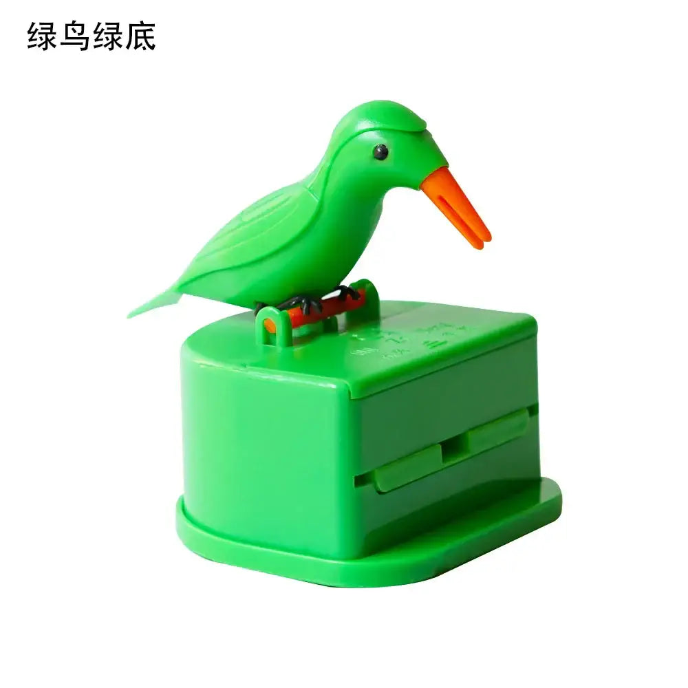 Green plastic birdie toothpick holder with orange beak perched on matching green base for kitchen storage dispenser