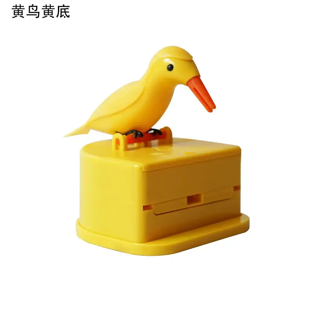 Yellow plastic birdie toothpick holder with orange beak perched on matching yellow base for kitchen storage