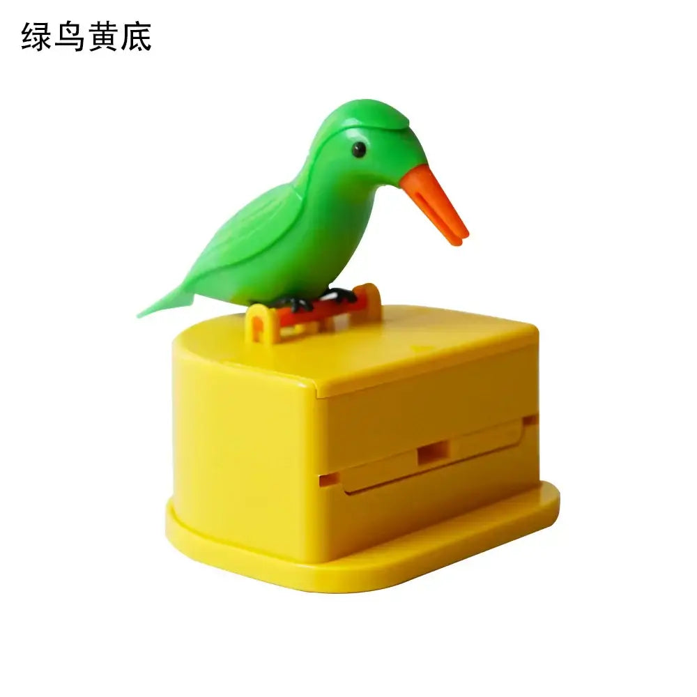 Green plastic birdie toothpick holder with an orange beak on a yellow base for kitchen storage and decorbites use