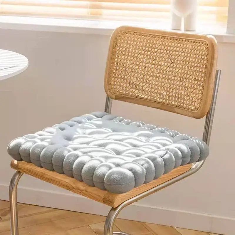 Light blue plush decorbites biscuit sofa cushion with quilted bubble texture on wooden chair for living room decor