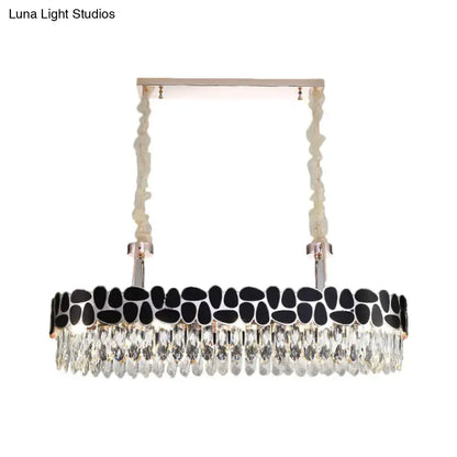 DecorBites black 8-head island lamp with modern clear crystal prisms and black stone accents in a sleek silver frame