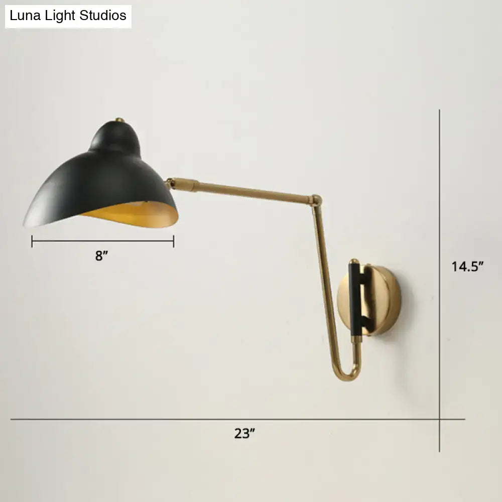 Black and brass duckbill reading light wall lamp with adjustable joint featuring matte black shade and gold interior