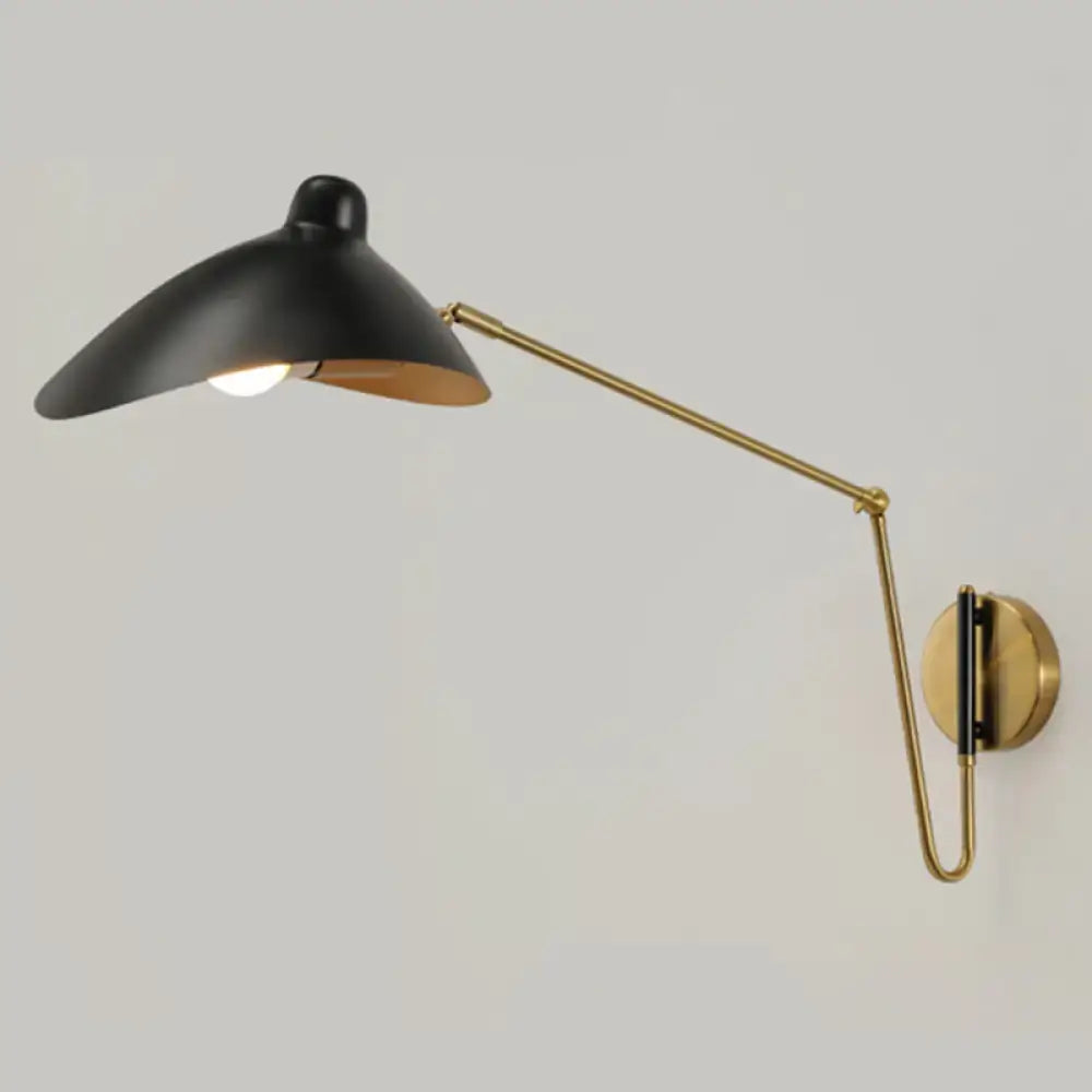 Black and brass adjustable joint wall lamp with sleek modern duckbill reading light design for bedroom use