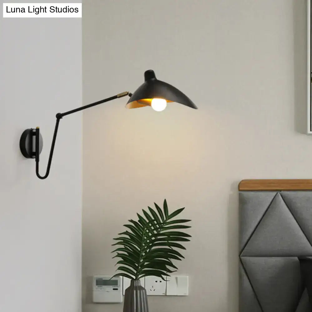 Black metal wall lamp with adjustable joint and conical duckbill reading light emitting warm bedroom illumination