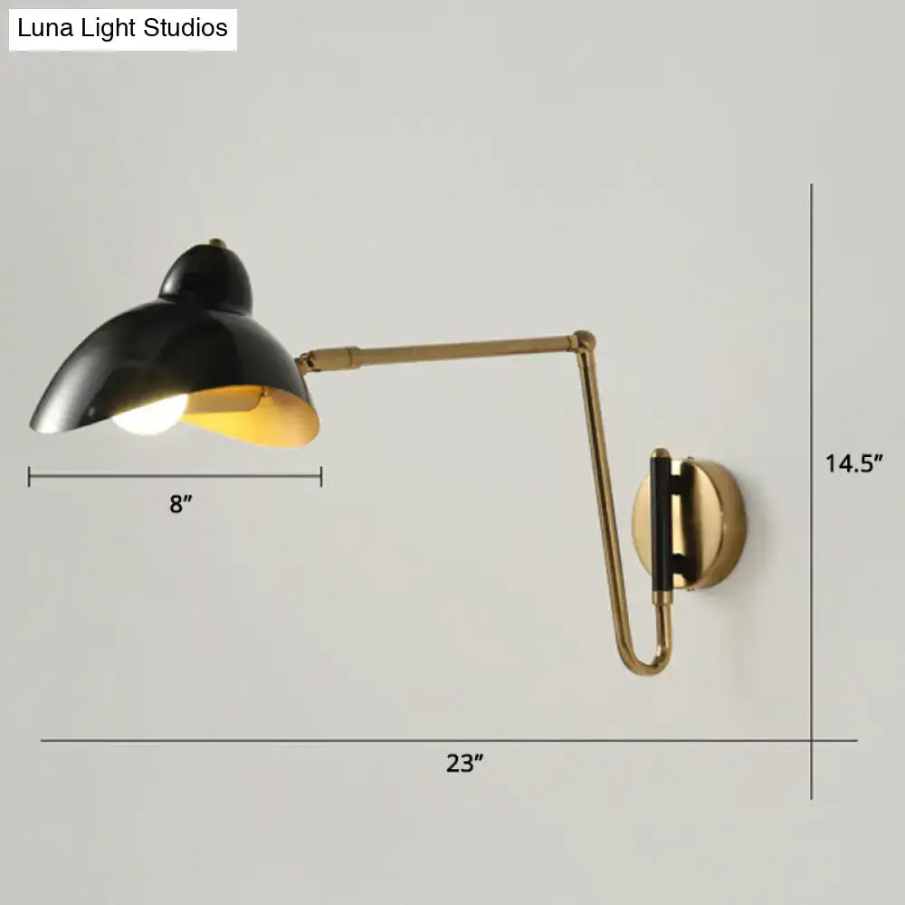 Black and brass wall lamp with adjustable joint and sleek duckbill reading light design for bedroom use