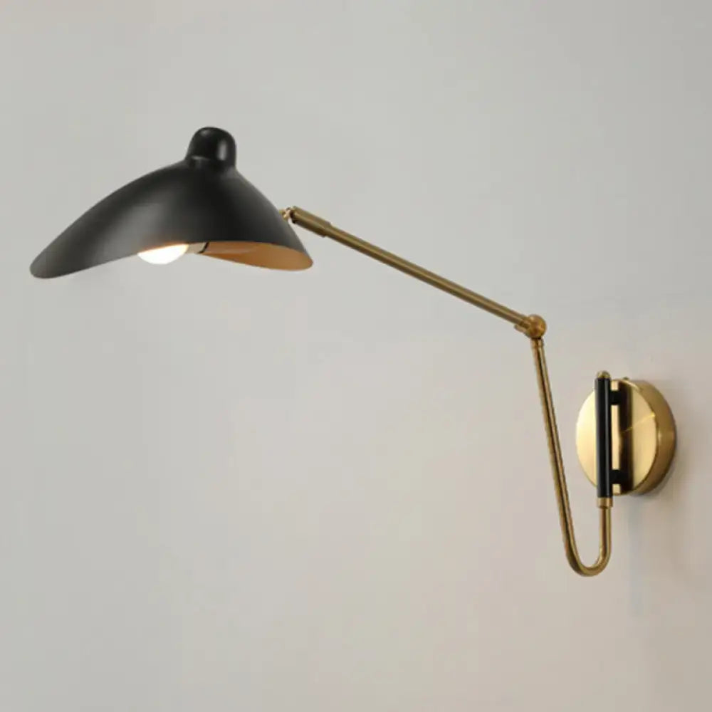 Black and brass adjustable joint wall lamp with a duckbill reading light design for bedroom use