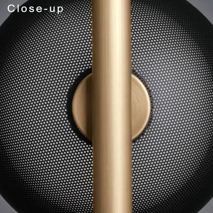 Gold-toned wall lamp with black metal arm and perforated black mesh shade for luxury bedroom decorbites black metal fixture