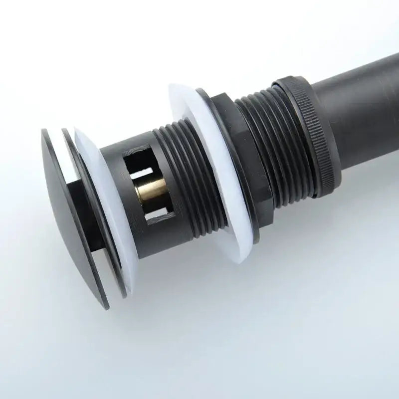 Black and chrome brushed nickel faucet sink drain stopper with black and white plastic and threaded metal connection