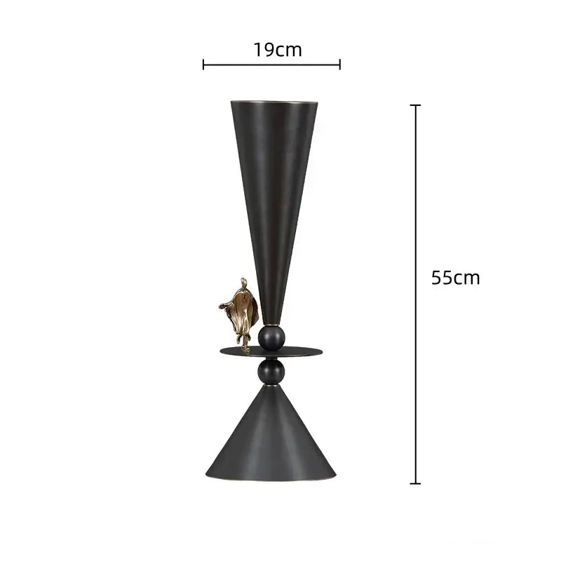 Black and gold decorbites bronze flower vase with matte black conical metal body and ornamental golden figurine centerpiece