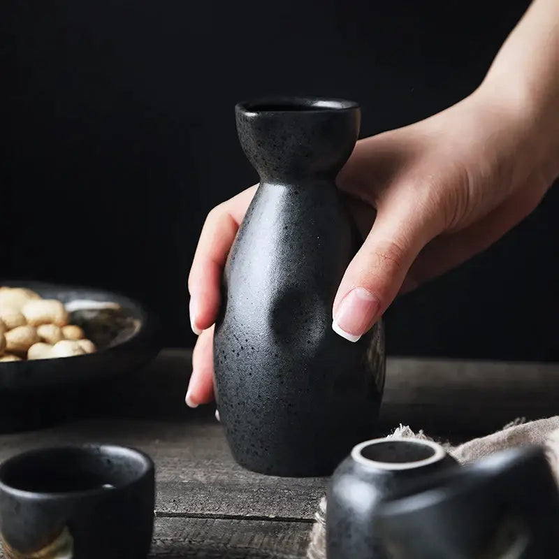 A sleek matte black ceramic sake liquor dispenser with speckled texture from decorbites ceramic sake set