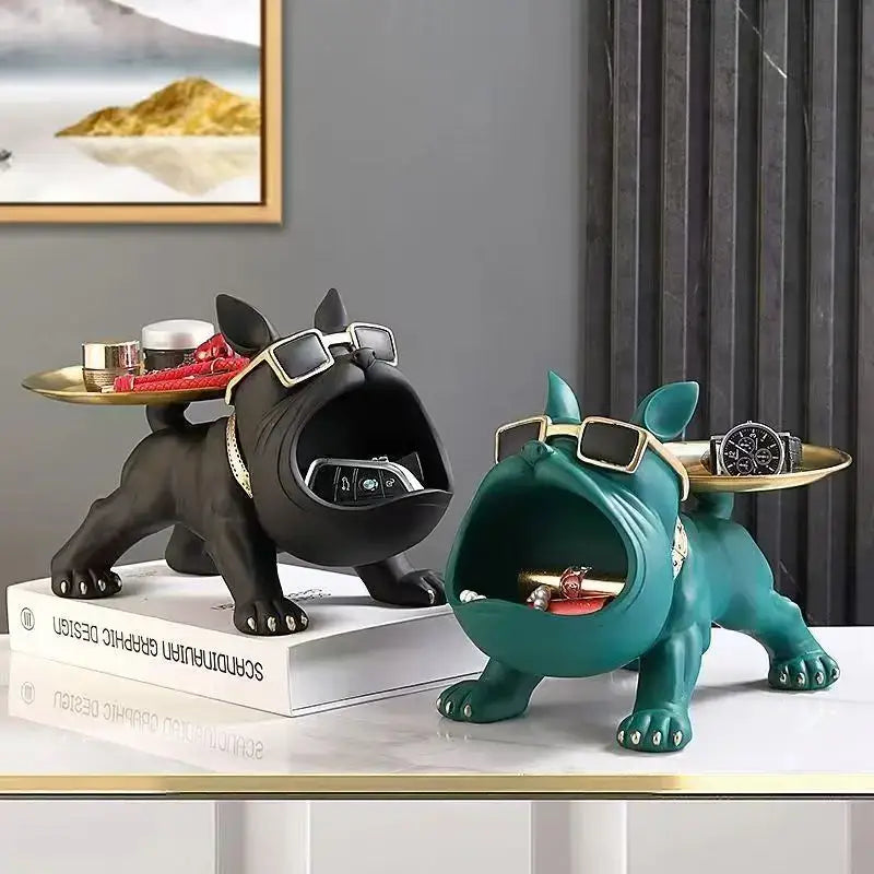 Black and teal french bulldog figurines with sunglasses holding gold trays designed for remote control storage