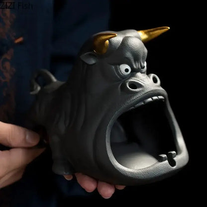 Black and gold ceramic ashtray shaped like a cartoon cow bull with wide open mouth for living room decorbites decor