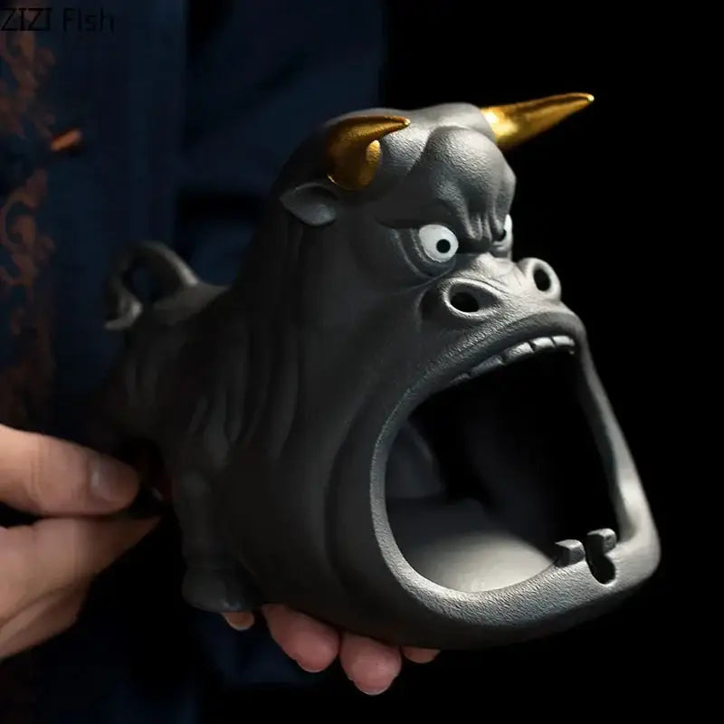 Black and gold ceramic ashtray shaped like a cartoon cow bull with wide open mouth for living room decorbites decor