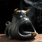 Black and gold ceramic ashtray shaped like a cartoon cow bull with gold horns and cigarette in mouth decorbites cartoon cow