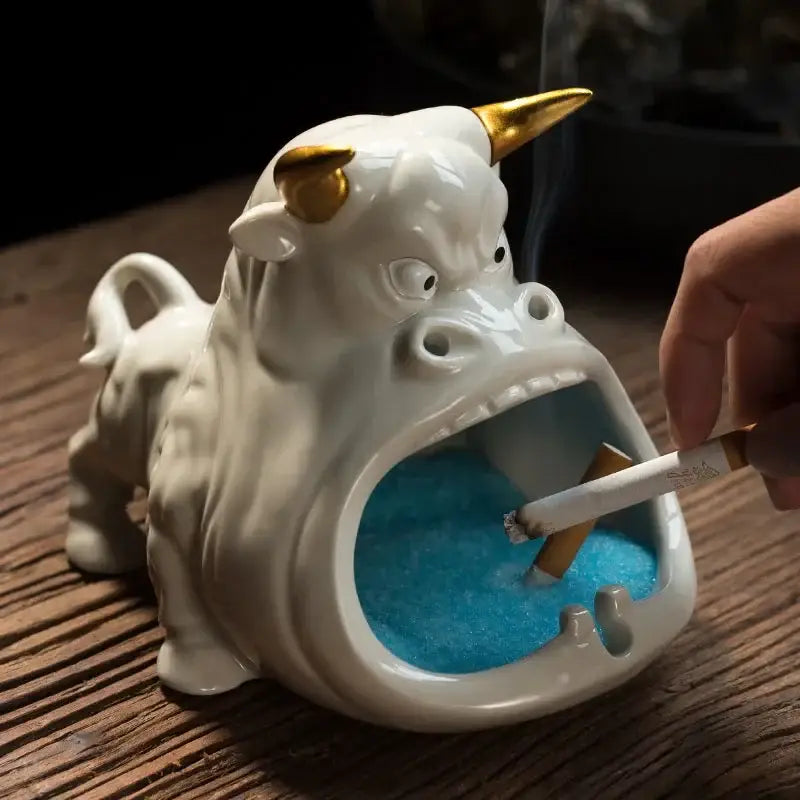 White ceramic ashtray shaped like a bull with gold horns and blue glittery interior for decorbites cartoon cow decor