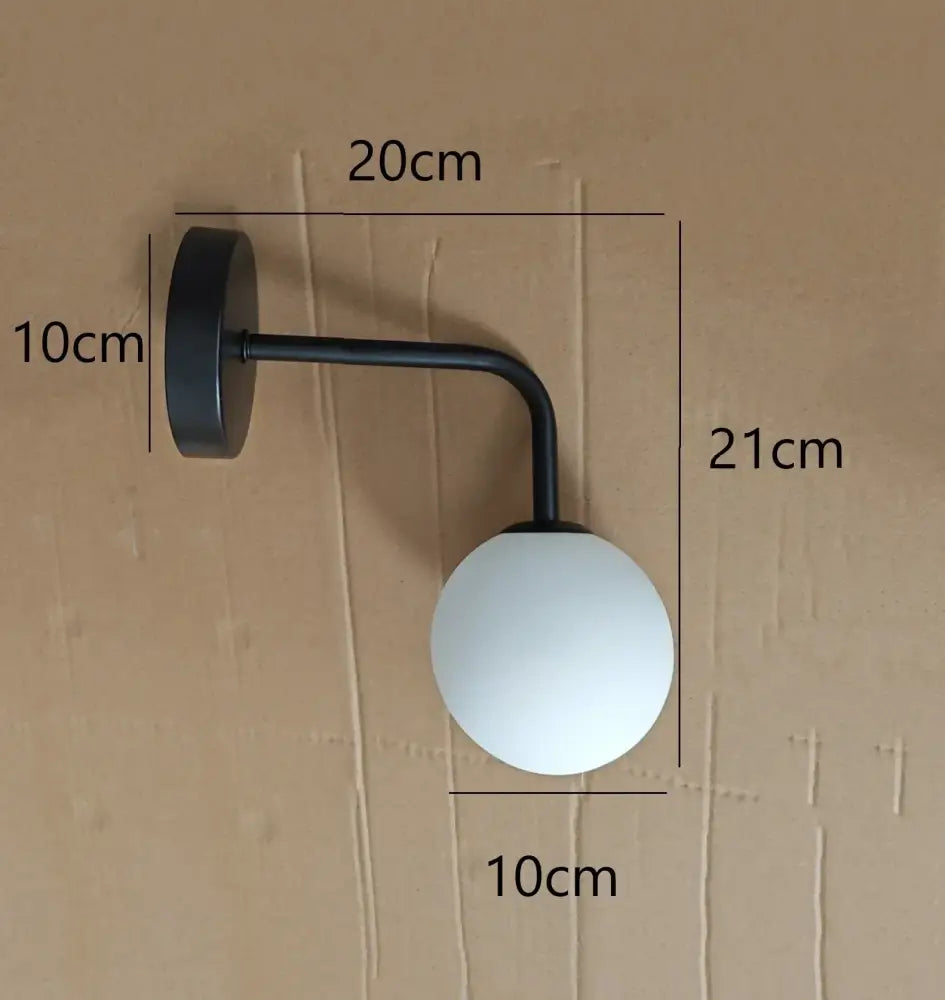 Black metal wall lamp with frosted white spherical glass shade decorbites golden glass led bedroom sconce
