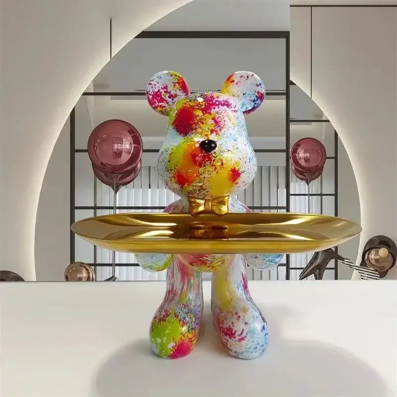 A black and gold decorbites graffiti bear figurine with a glossy finish holding a golden tray for living room decor