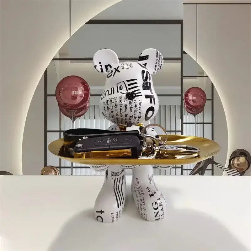 White bear figurine with black typographic decorbites graffiti bear print and gold tray for living room decor