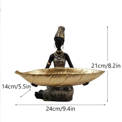 Black woman resin figurine in black and gold attire holding a leaf-shaped tray for living room decorbites black woman