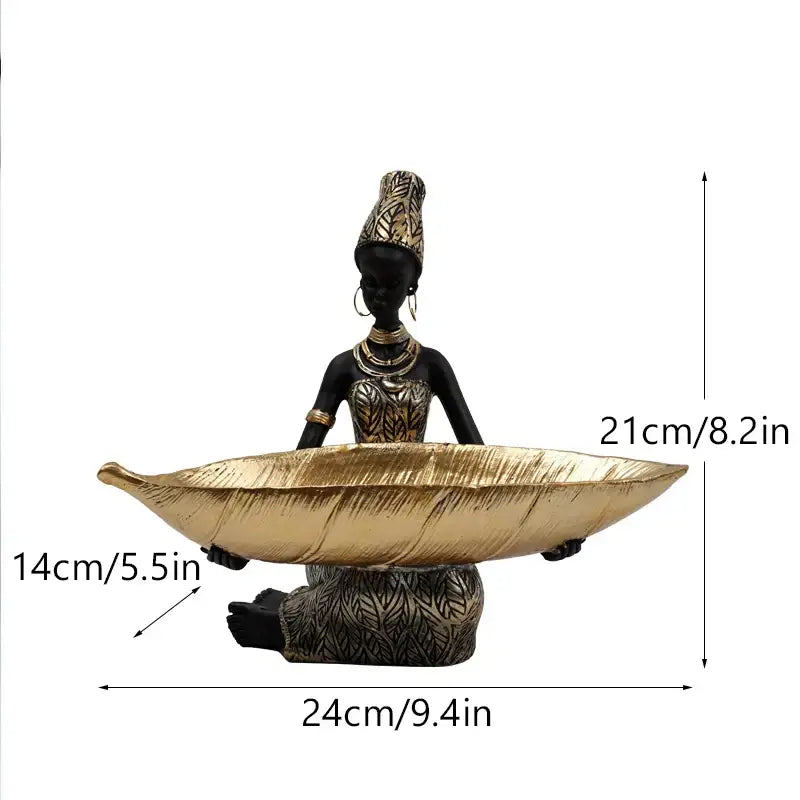Black woman resin figurine in black and gold attire holding a leaf-shaped tray for living room decorbites black woman