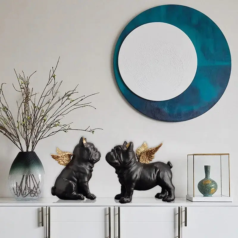 Black resin french bulldog dog sculpture with golden wings displayed on white shelf for living room decor