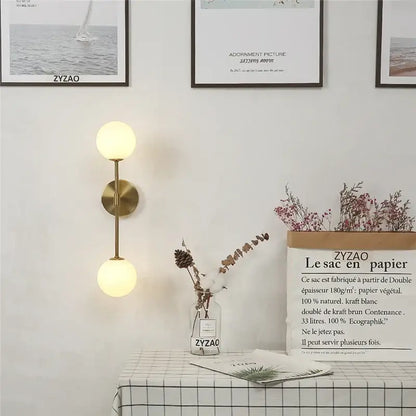 Gold-toned wall lamp decorbites golden glass led with two softly glowing spherical glass shades for bedroom sconce decor